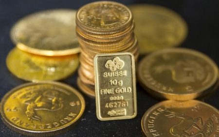 Gold prices steady below record highs with rate cuts in focus